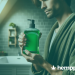 a man holding green mouthwash in a bathroom - hemppedia